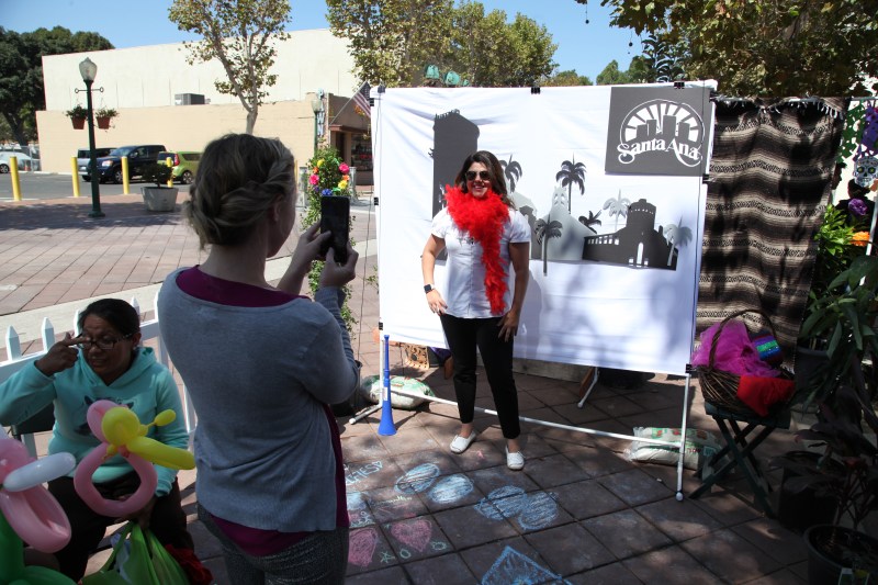 Michele Martinez, right, posing at the Santa Ana photo booth during a Park(ing) Day event in 2016. Photo by Kristopher Fortin