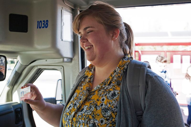 Josephine Hazelton shows her student ID/bus pass to a Turlock Transit bus driver. Photo by Minerva Perez