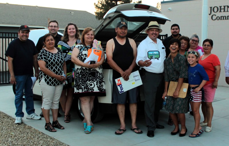 Huron residents pose in front of a Chevy Volt with Executive Director of Valley LEAP and Huron Mayor Rey Leon (with straw hat). Photo courtesy Rey Leon.