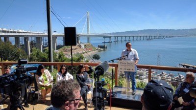 Renee Rivera, Executive Director of Bike East Bay, at the podium before the ribbon cutting for Yerba Buena Island Vista Point. Photo: Streetsblog/Rudick