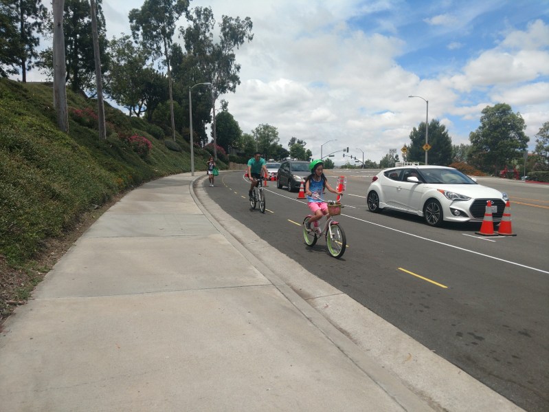 Anaheim Residents test out the pop-up parking-protected bikeway in Yorba Linda. Once completed, it would be the first of its kind in the County. Photos by Kristopher Fortin