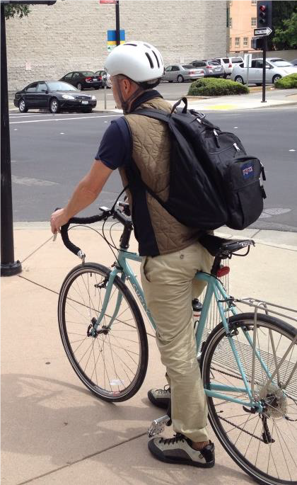 This bike commuter carries a backpack that measures his exposure to pollution. Photo: CARB