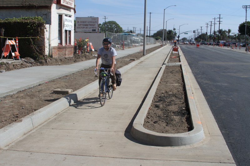 Edgar Arellano, Anaheim resident, rides on the City of Santa Ana's first protected bike lane on Bristol Street. Kristopher Fortin/Streetsblog CA
