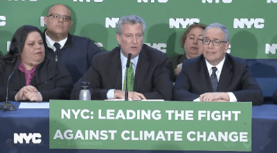 The sign says Bill de Blasio is leading the fight against climate change, but his transportation policies say otherwise.