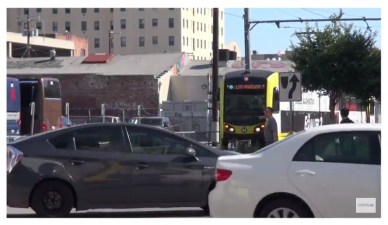 Can you spot the Expo Line train waiting behind all those cars downtown? Capture from Streetsfilms