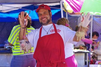 A street vendor in the piñata district holds up two cochinitos. Should the vending ordinance pass as currently structured, the presence of vendors in areas like the piñata district could be significantly curtailed. Sahra Sulaiman/ Streetsblog L.A.