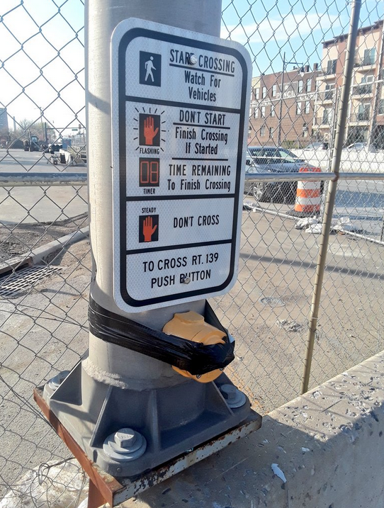 A DIY prescription: Taping a rock to a beg button might guarantee an automatic pedestrian phase--but this doesn't always work. Photo from Twitter user Ollie