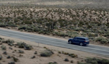 An SUV drives in the desert