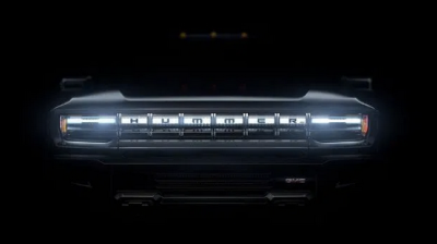 front hood of a car looming out of the dark