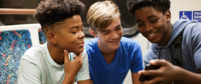 Young people looking at a cell phone