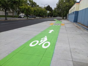 A "protected" bike lane on Market, at least on this bus boarding island at 14th. Photos: Streetsblog/Rudick