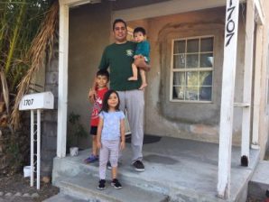 Westmont resident Eric Duran and his children - in front of the home that Caltrans is pushing to evict them from. Photos by Joe Linton/Streetsblog L.A.
