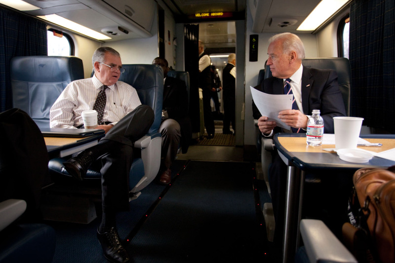 Joe Biden and former Secretary of Transportation Ray LaHood talk about high speed rail expansion while traveling from Washington, DC to Philadelphia, PA an Amtrak Acela train, Feb. 8, 2011. (Official White House Photo by David Lienemann)