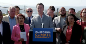 Governor Newsom surrounded by California state legislators